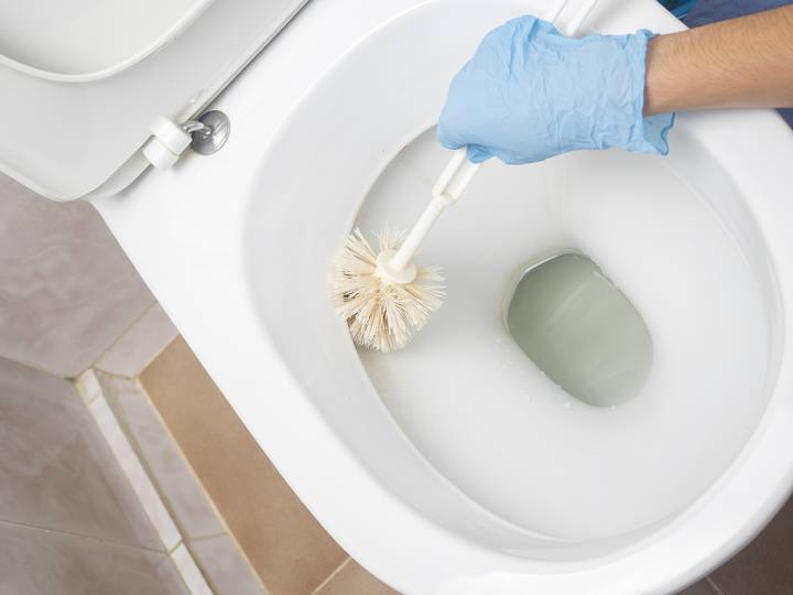 Clean the toilet rim to flush better