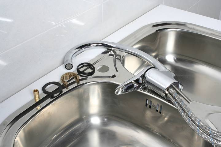 A kitchen faucet is running slow because of its broken seal.