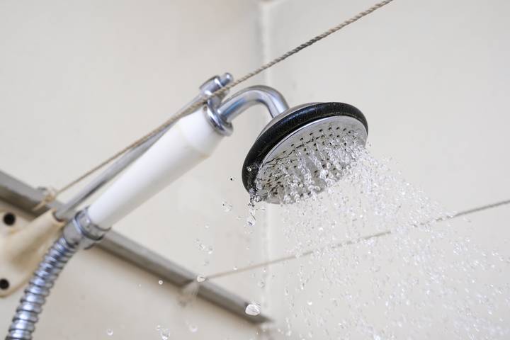A shared water line might explain why there is low water pressure in the shower.