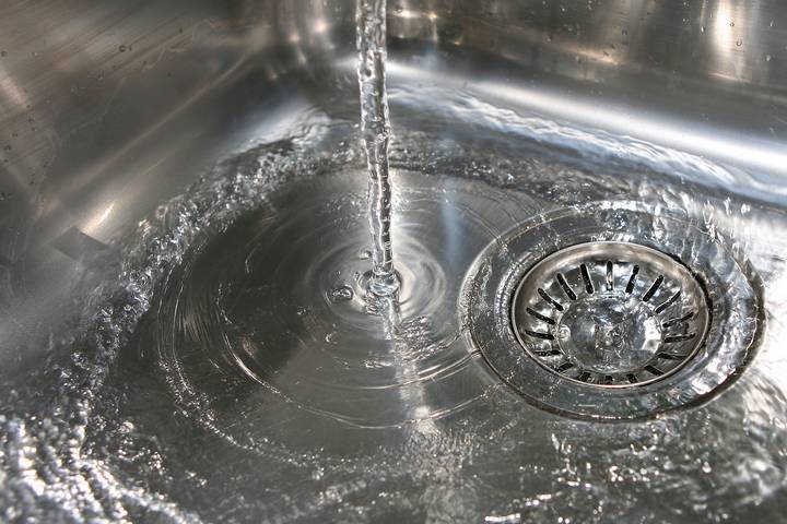Sign #3 - Slow draining water in clogged kitchen sink