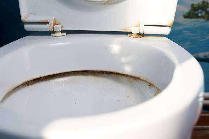 The toilet water smells bad because of bacteria overgrowth.