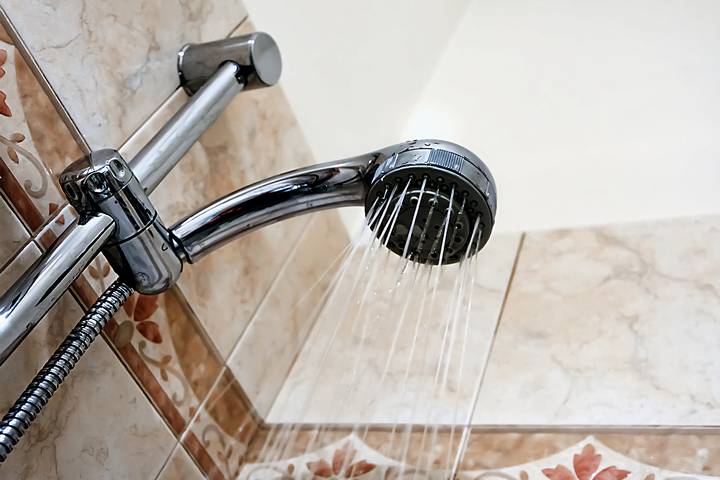 Clogging might cause a dripping shower head.