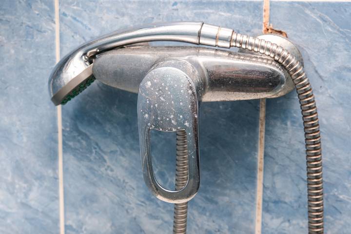 An old valve might cause a dripping shower head when water is off.