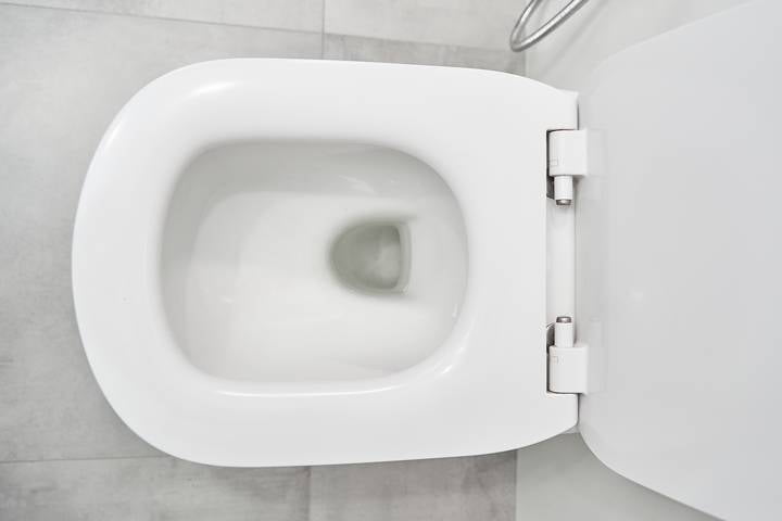 The clogged toilet drain causes low water level in the bowl.
