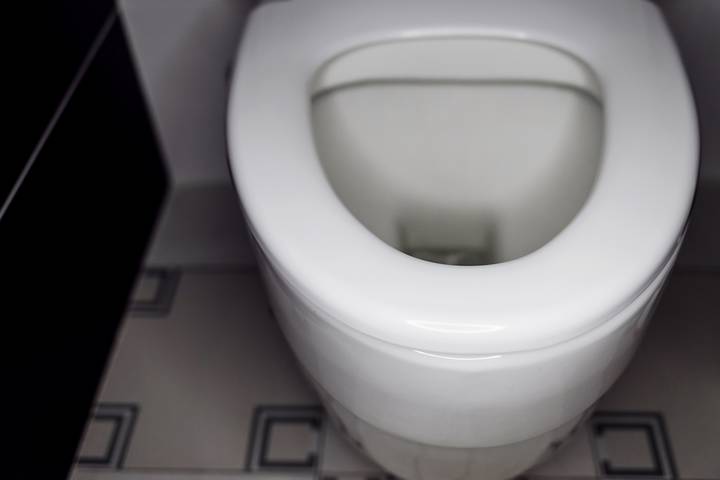A leak causes a low water level in the toilet bowl.